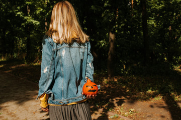 Halloween pumpkin. Woman holding a scary face pumpkin. Happy Halloween party holiday. Celebrate...