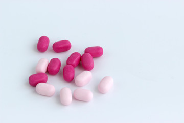 Obraz na płótnie Canvas colorful pills on white background, handful of pills