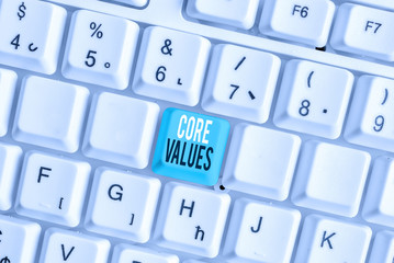 Writing note showing Core Values. Business concept for belief demonstrating or organization views as being importance White pc keyboard with note paper above the white background