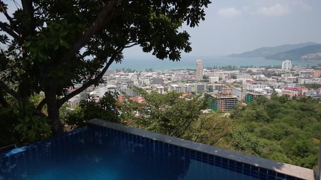 Infinity Pool Overlooks City Skyline - great view of colored houses and hotels, trees, sea and sky
