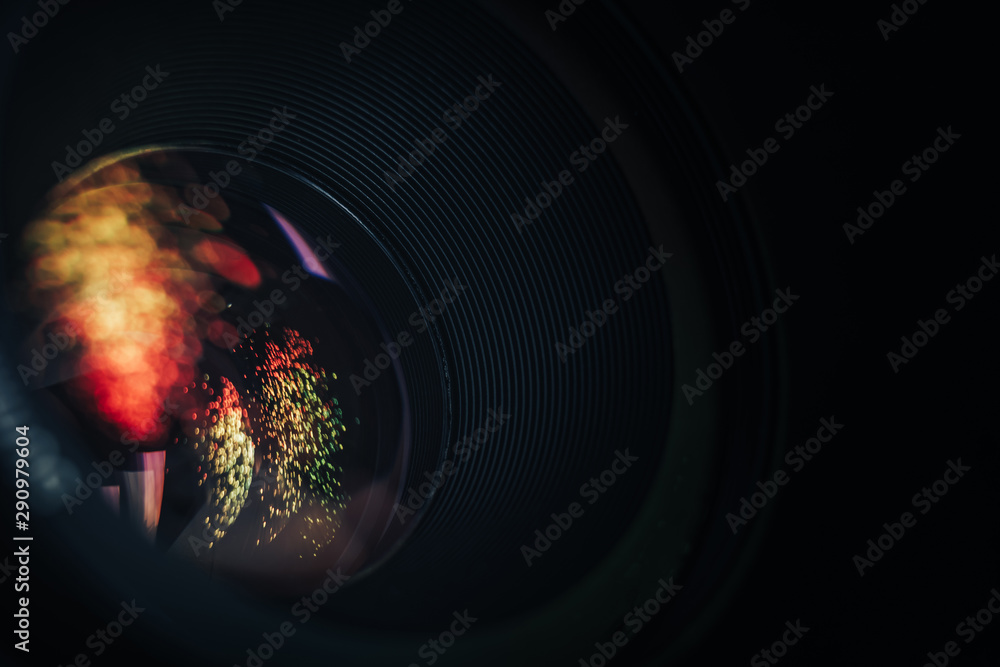 Poster beautiful camera aperture lens with multi colored shine glass reflection. macro view.