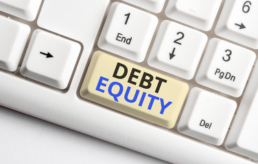 Text sign showing Debt Equity. Business photo showcasing dividing companys total liabilities by its stockholders White pc keyboard with empty note paper above white background key copy space