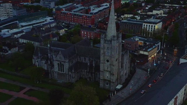 Aerial orbital of St Patrick’s Cathedral and park at night in Dublin