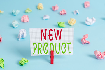 Conceptual hand writing showing New Product. Concept meaning goods and services that differ in their characteristics Colored clothespin rectangle shaped paper blue background