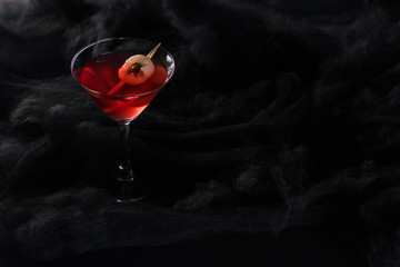 red decorated Halloween cocktail in black clouds