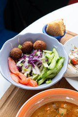 Traditional israeli salad with fresh vegetables and deep fried falafel as a part of healthy lunch