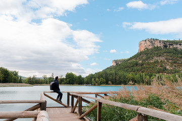 Adventurer man in a footbridge on a lake