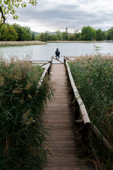 Adventurer man in a footbridge on a lake
