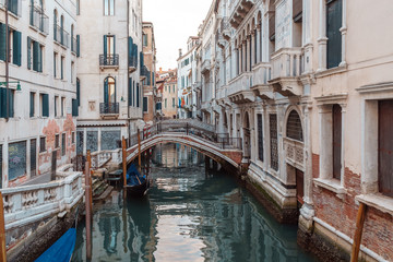 Naklejka na ściany i meble Boats on narrow canal between colorful historic houses in Venice.