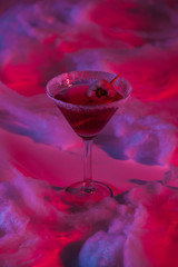 Halloween cocktail with cotton wool in red lighting