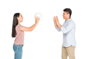 cheerful asian man and woman playing volleyball isolated on white