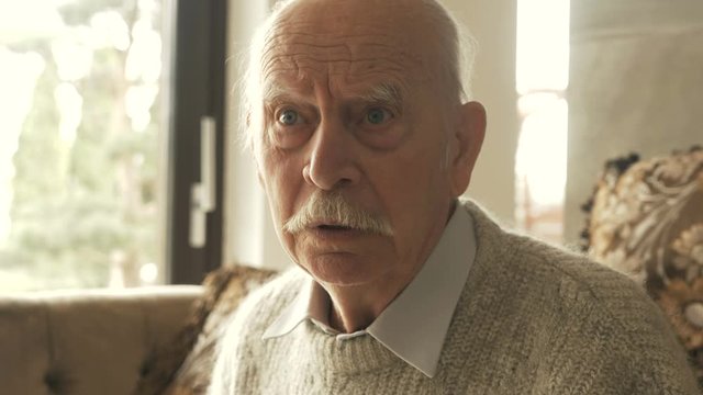 domestic violence concept. Closeup portrait of a very grumpy grouchy senior man. Who is arguing with someone