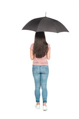 back view of young asian man standing under black umbrella on white background