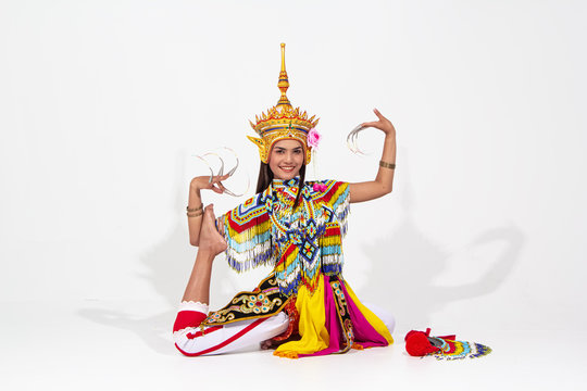 The beautiful woman wearing Thai southern folk dancing costume,made from colorful bead,put headress on her head,showing basic pattern of dancing