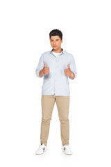 young asian man showing thumbs up while looking at camera on white background