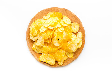 Junk food concept with heap of potato crisps on white background top view