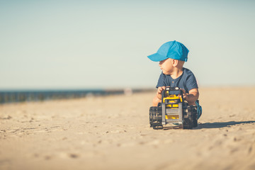 Toddler boy playing on a sunny beach