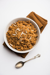 Wheat flour Halwa or Shira /  Atte ka Halva, Popular healthy dessert or breakfast menu from India. served in a bowl or plate. selective focus