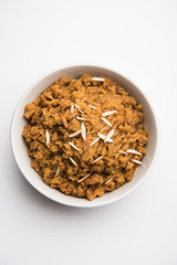 Wheat flour Halwa or Shira /  Atte ka Halva, Popular healthy dessert or breakfast menu from India. served in a bowl or plate. selective focus