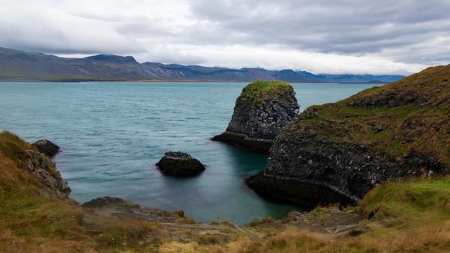 Timelapse view of volcanic basalt formations by a fjord in West Iceland