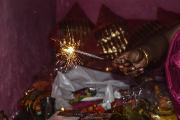 Indian lady playing with fire cracker rose and candle on indian festival diwali deepawali with fire...