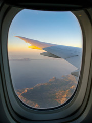 Dawn of the sun in the window of an airplane
