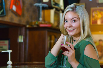Girl with alcohol glass in pub club