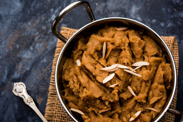 Wheat flour Halwa or Shira or porridge /  Atte ka Halva, Popular healthy dessert or breakfast menu from India. served in a bowl or plate. selective focus