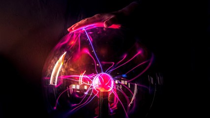 abstract background with the plasma ball, hand and the lights