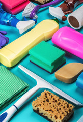 assortment of different cleaning products for the house on a colored background.