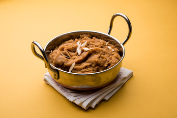 Wheat flour Halwa or Shira or porridge /  Atte ka Halva, Popular healthy dessert or breakfast menu from India. served in a bowl or plate. selective focus