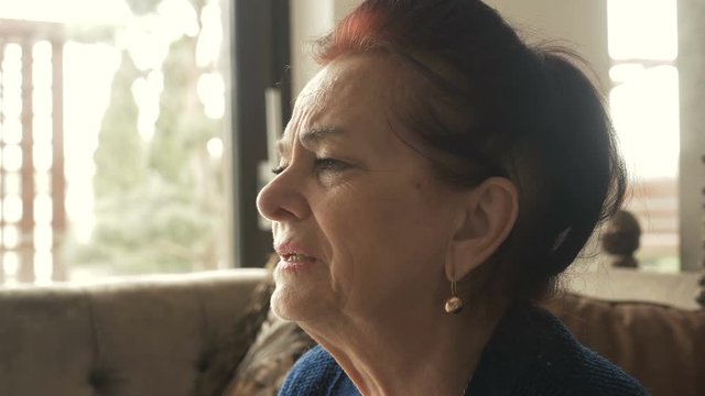 Sad thoughtful anxious mature senior woman feeling lonely worried concerned about problems, pensive depressed upset middle aged widow lady sitting alone grieving thinking of getting older loneliness