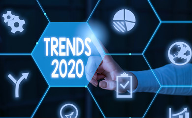 Word writing text Trends 2020. Business photo showcasing Upcoming year prevailing tendency Widely Discussed Online Male human wear formal work suit presenting presentation using smart device