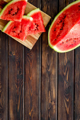 Pieces of watermelon on wooden background top view space for text