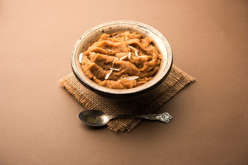 Wheat flour Halwa or Shira or porridge /  Atte ka Halva, Popular healthy dessert or breakfast menu from India. served in a bowl or plate. selective focus