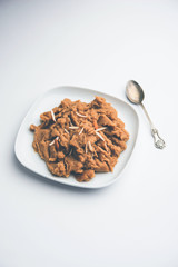 Wheat flour Halwa or Shira or porridge /  Atte ka Halva, Popular healthy dessert or breakfast menu from India. served in a bowl or plate. selective focus