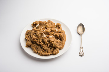 Wheat flour Halwa or Shira or porridge /  Atte ka Halva, Popular healthy dessert or breakfast menu from India. served in a bowl or plate. selective focus