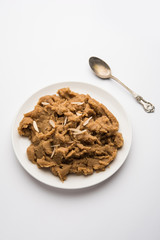 Wheat flour Halwa or Shira or porridge /  Atte ka Halva, Popular healthy dessert or breakfast menu from India. served in a bowl or plate. selective focus