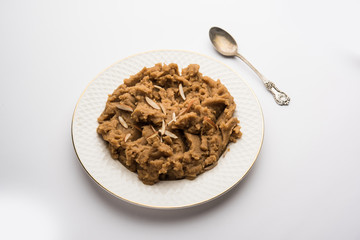 Wheat flour Halwa or Shira or porridge /  Atte ka Halva, Popular healthy dessert or breakfast menu from India. served in a bowl or plate. selective focus