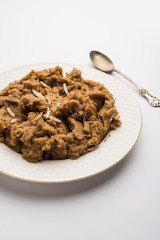 Wheat flour Halwa or Shira or porridge /  Atte ka Halva, Popular healthy dessert or breakfast menu from India. served in a bowl or plate. selective focus
