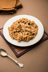 Wheat flour Halwa or Shira or porridge /  Atte ka Halva, Popular healthy dessert or breakfast menu from India. served in a bowl or plate. selective focus