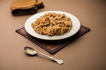Wheat flour Halwa or Shira or porridge /  Atte ka Halva, Popular healthy dessert or breakfast menu from India. served in a bowl or plate. selective focus