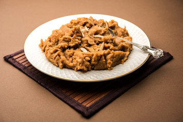 Wheat flour Halwa or Shira or porridge /  Atte ka Halva, Popular healthy dessert or breakfast menu from India. served in a bowl or plate. selective focus