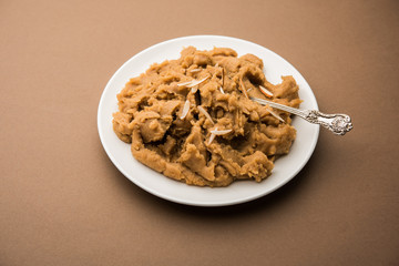 Wheat flour Halwa or Shira or porridge /  Atte ka Halva, Popular healthy dessert or breakfast menu from India. served in a bowl or plate. selective focus