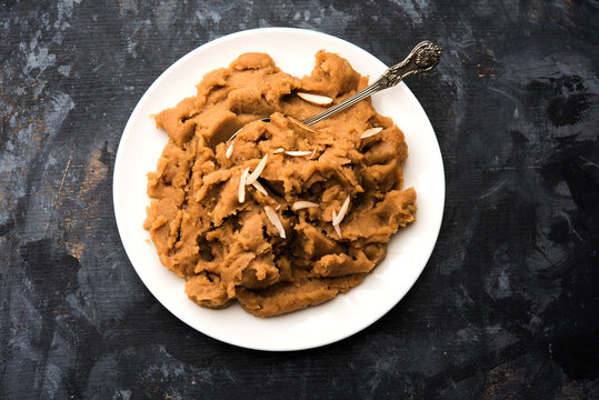 Wheat flour Halwa or Shira or porridge /  Atte ka Halva, Popular healthy dessert or breakfast menu from India. served in a bowl or plate. selective focus