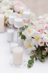 Fototapeta na wymiar Stylish decoration of the wedding with flowers and candles in the style of minimalism