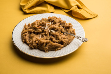 Wheat flour Halwa or Shira or porridge /  Atte ka Halva, Popular healthy dessert or breakfast menu from India. served in a bowl or plate. selective focus