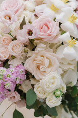 Gentle white, pink fresh wedding flowers. A large bouquet of fresh colors of light on the groom and bride 's table