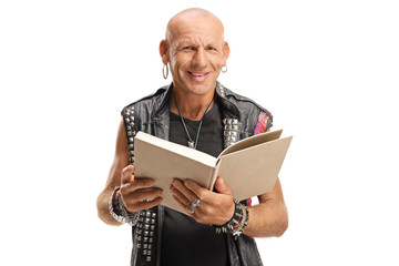 Punker in leather vest holding a book and smiling at the camera