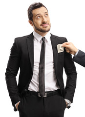 Businessman taking money for bribe and looking away